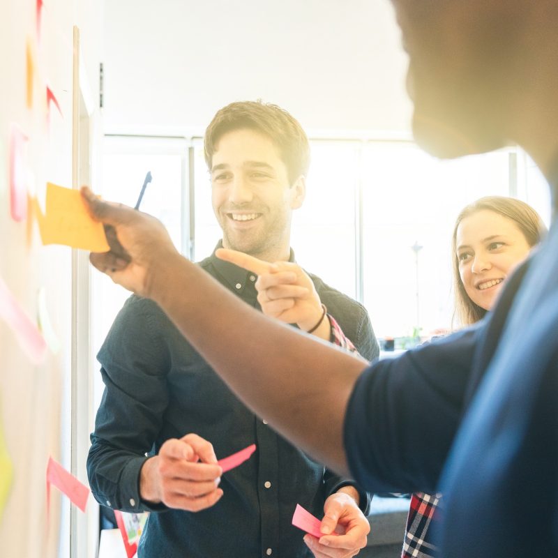 Happy employee people on a brainstorming at startup office